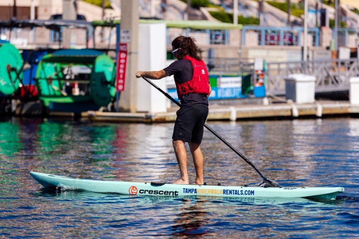 a person riding a surf board on a body of water