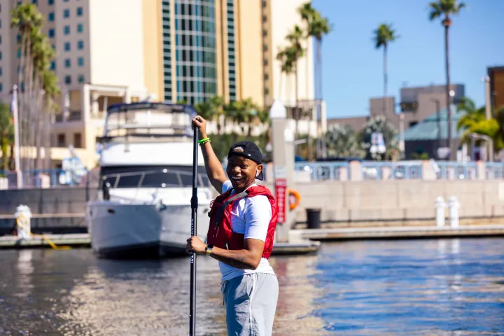 a man standing next to a body of water