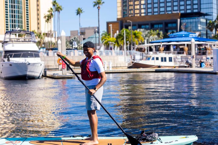 a man standing on a boat in the water