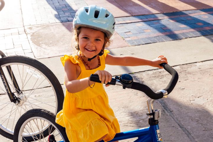 Young girl with helmet on bike