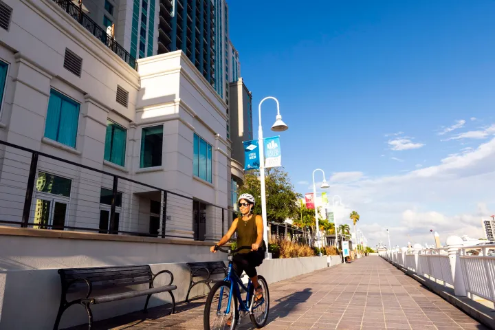 a person riding a bicycle in front of a building