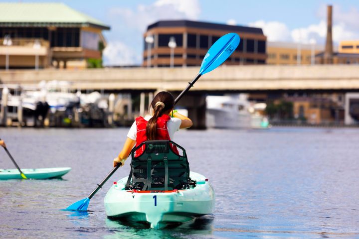A women kayaking in front of Marriott