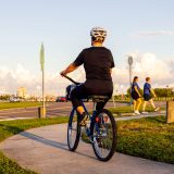 women riding on the back of a bicycle